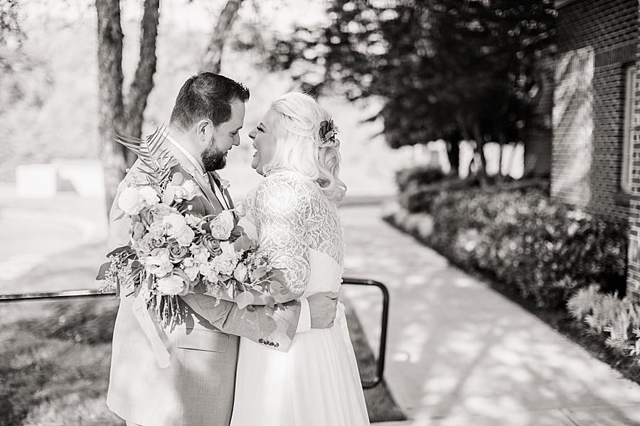 black and white photo of bride and groom at shoreline elopement