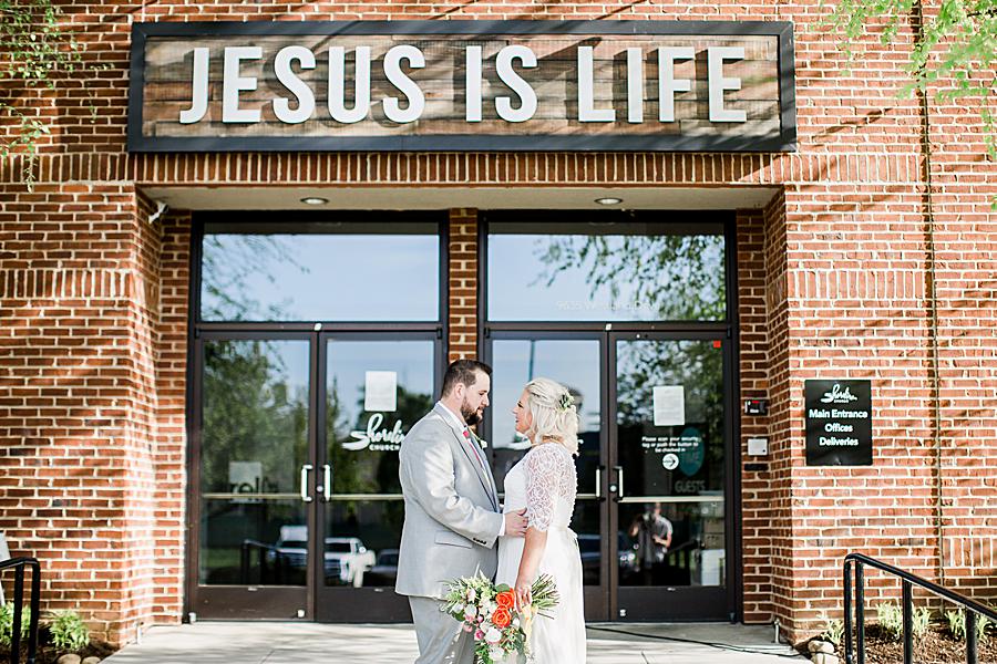 Jesus is Life sign behind newlywed couple