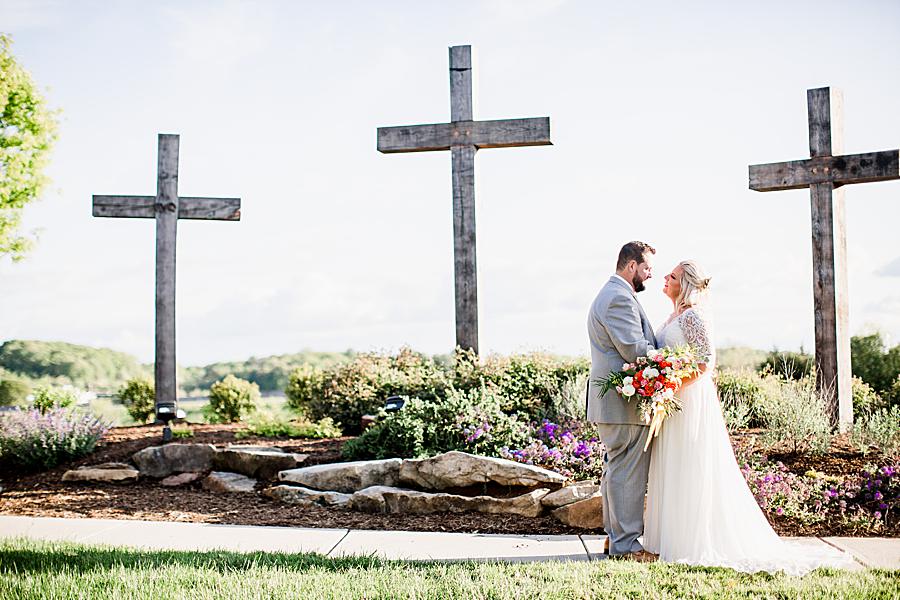 husband and wife in front of 3 crosses