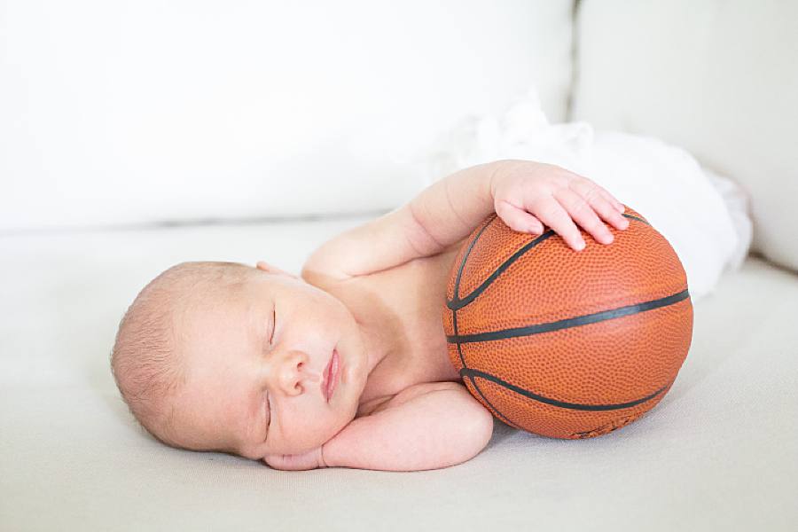 hand on basketball at sporty newborn