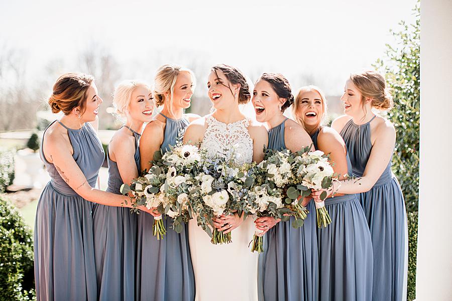 bride and bridesmaids laughing at spring wedding at castleton