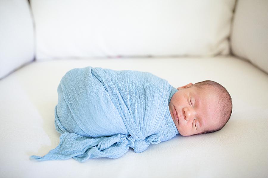 baby in a blue swaddle at the studio