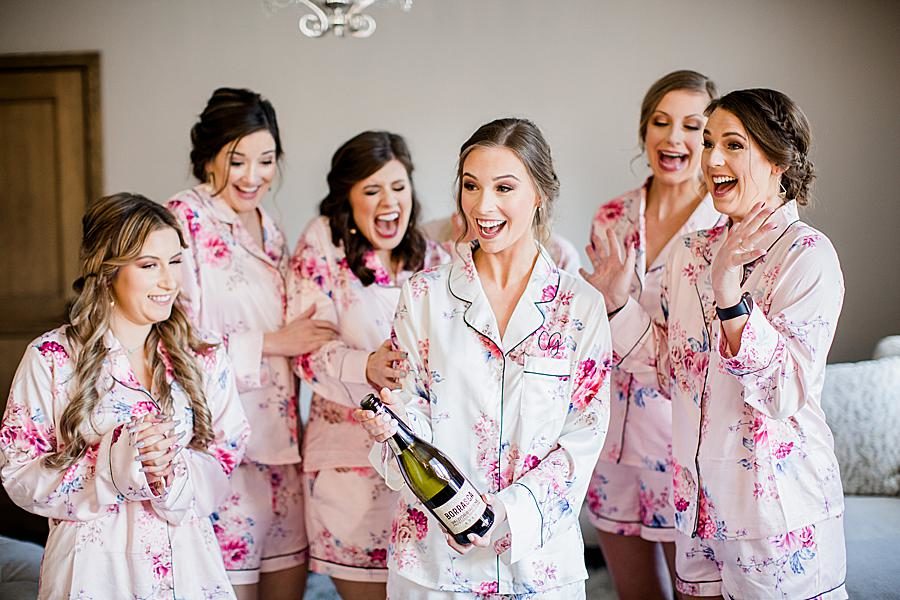 Popping champagne at this The Press Room Wedding by Knoxville Wedding Photographer, Amanda May Photos.