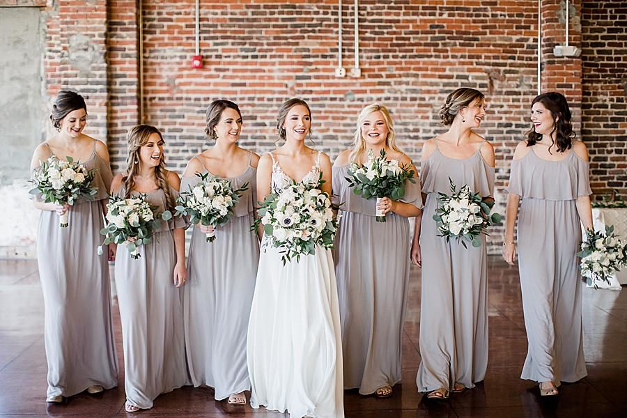 Holding bouquets at this The Press Room Wedding by Knoxville Wedding Photographer, Amanda May Photos.