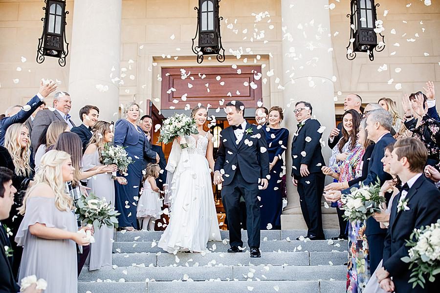 Throwing rose petals at this The Press Room Wedding by Knoxville Wedding Photographer, Amanda May Photos.