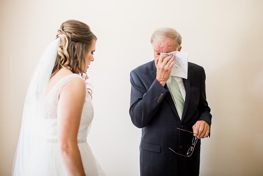 father of the bride wiping away tears