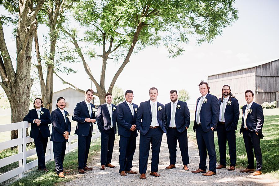 groomsmen in navy suits at the white rose