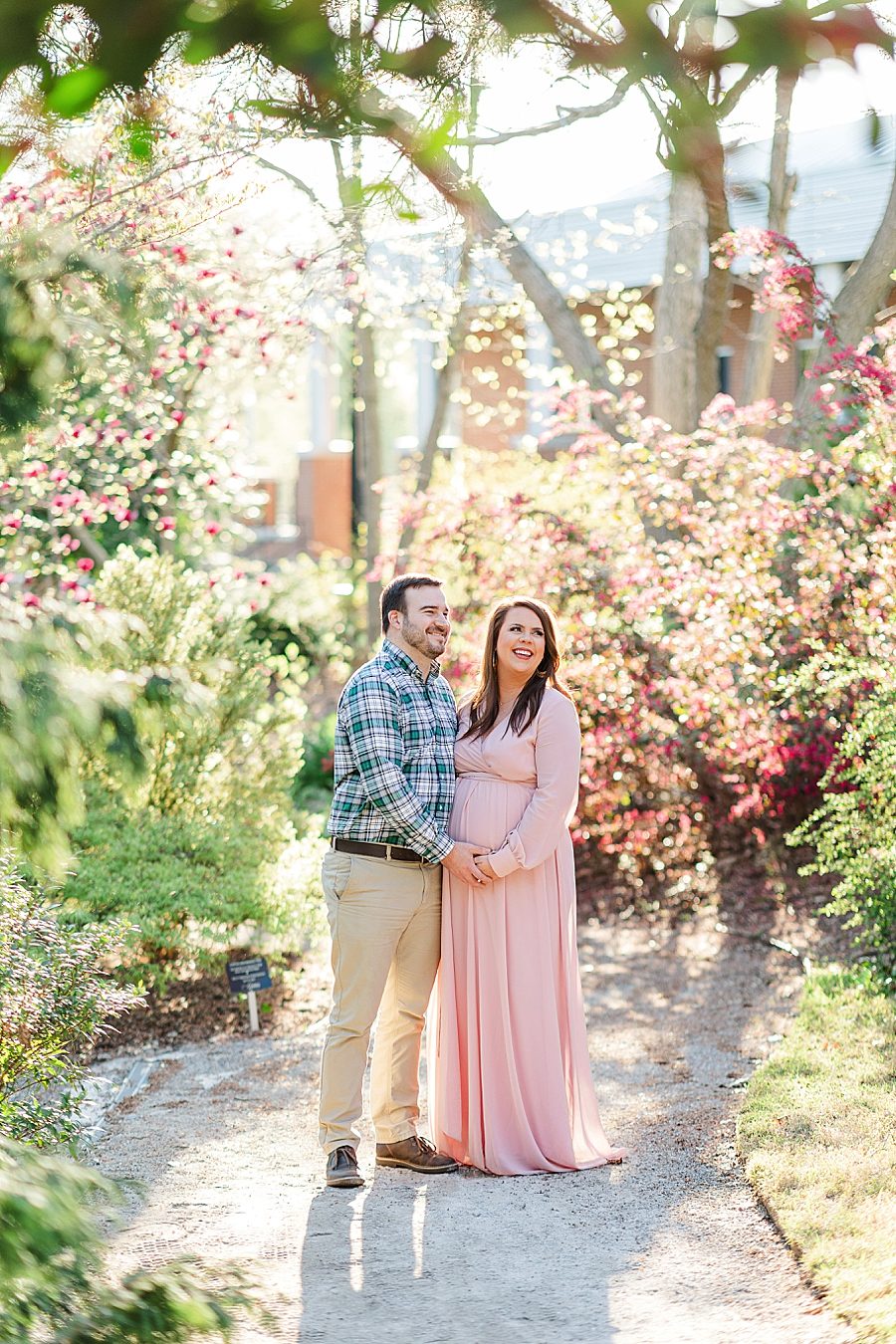 looking off and laughing at ut gardens maternity session