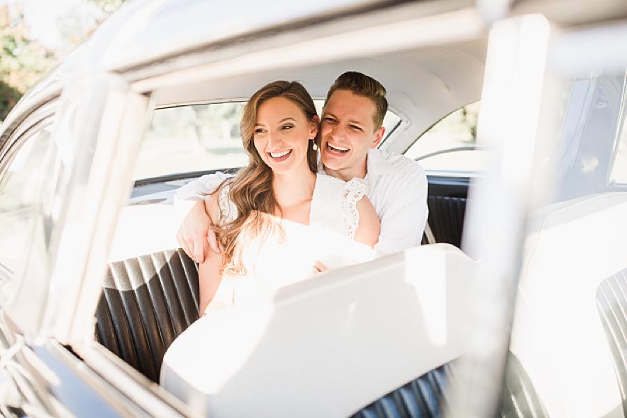 Laughing in a vintage car engagement