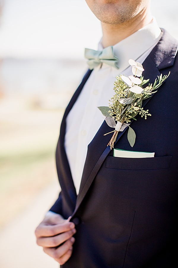 groom wearing boutonniere at whitestone
