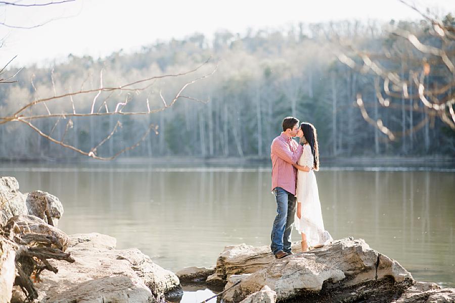 couple standing on rocks at their winter engagement at melton hill park