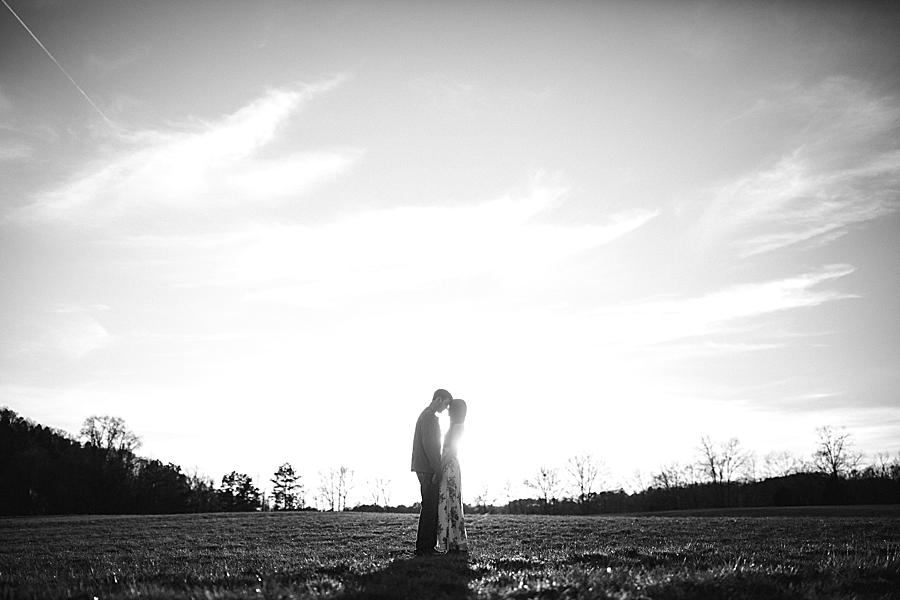 black and white photo of couple at sunset