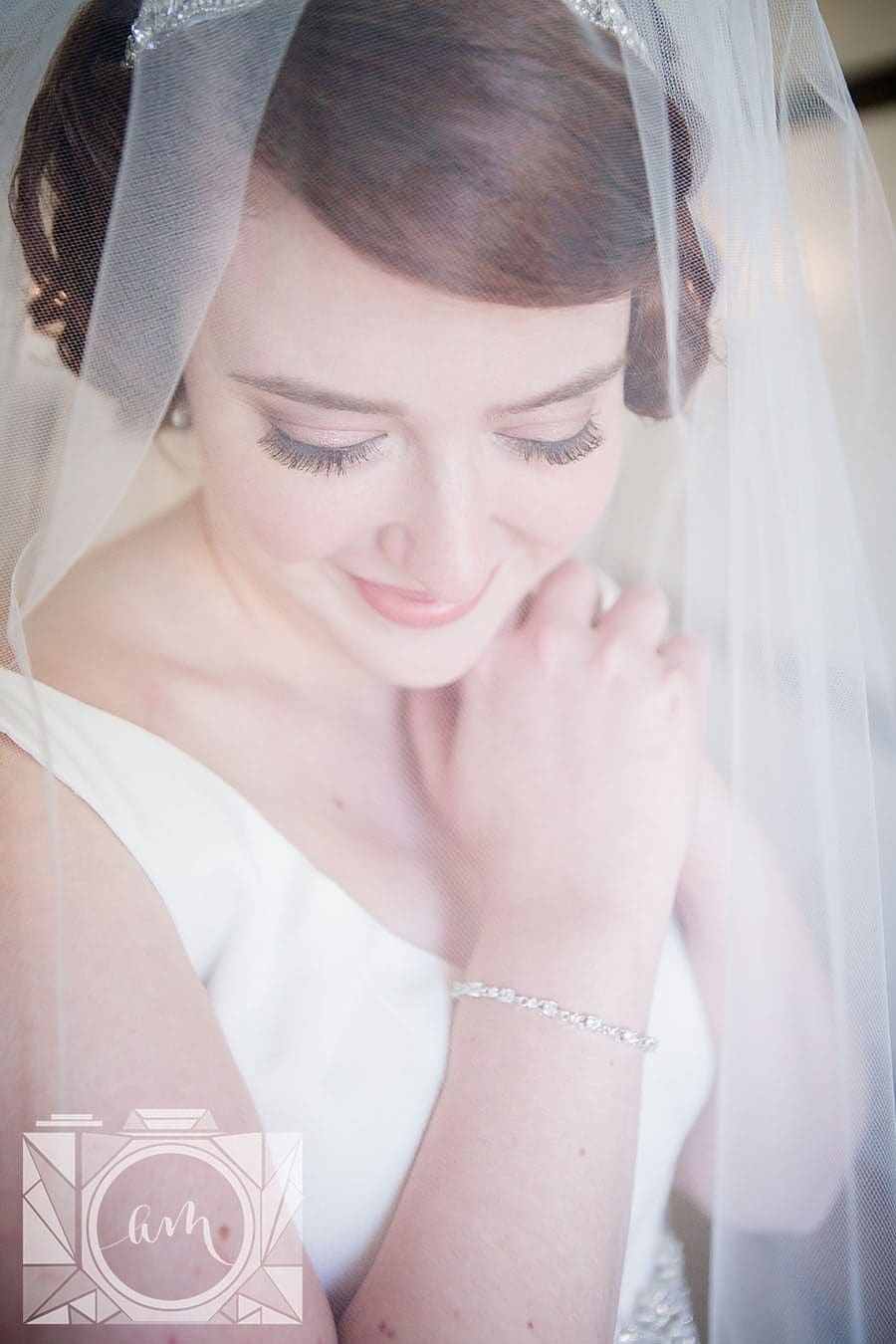 Bride looking down under vail at this favorite wedding photo by Knoxville Wedding Photographer, Amanda May Photos.