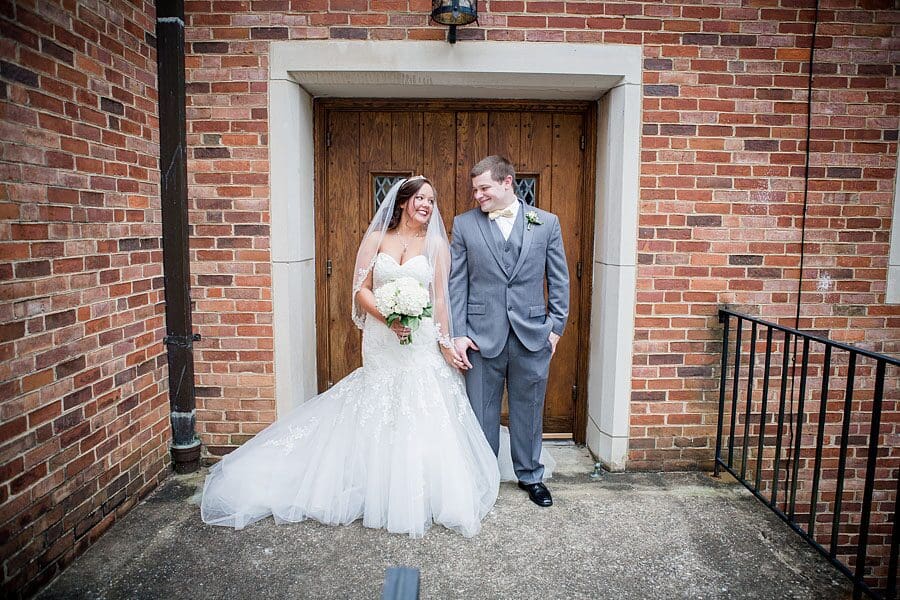 Couple in front of doors at this favorite wedding photo by Knoxville Wedding Photographer, Amanda May Photos.