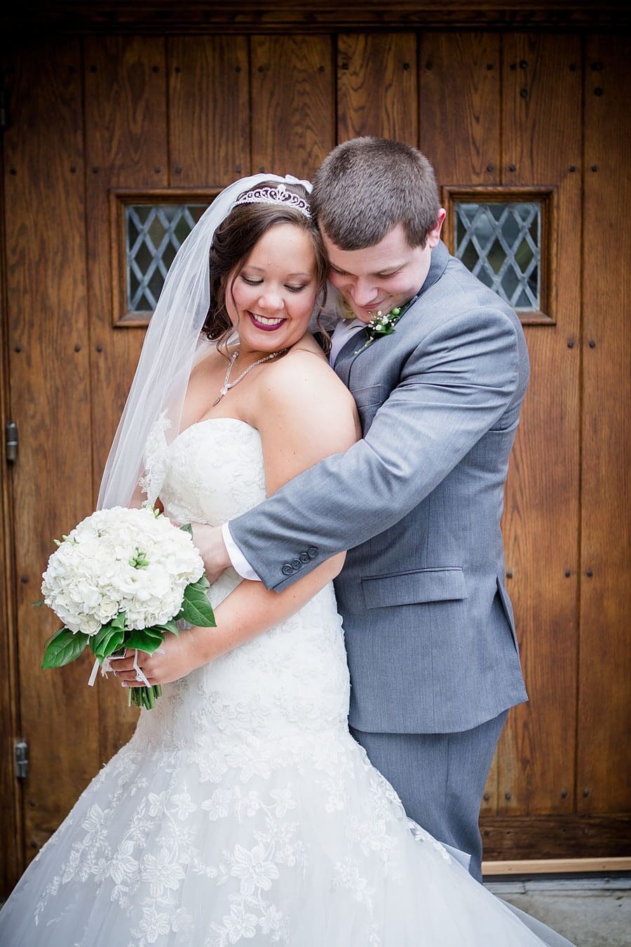 Couple hugging from behind at this favorite wedding photo by Knoxville Wedding Photographer, Amanda May Photos.