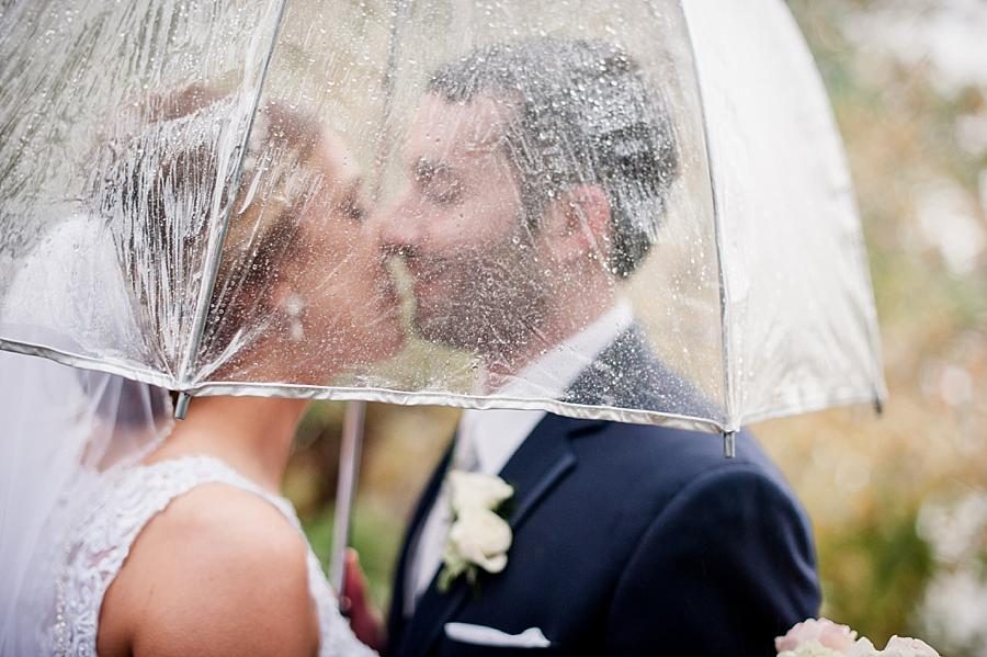 Kissing under an umbrella at these 2017 favorite weddings by Knoxville Wedding Photographer, Amanda May Photos.