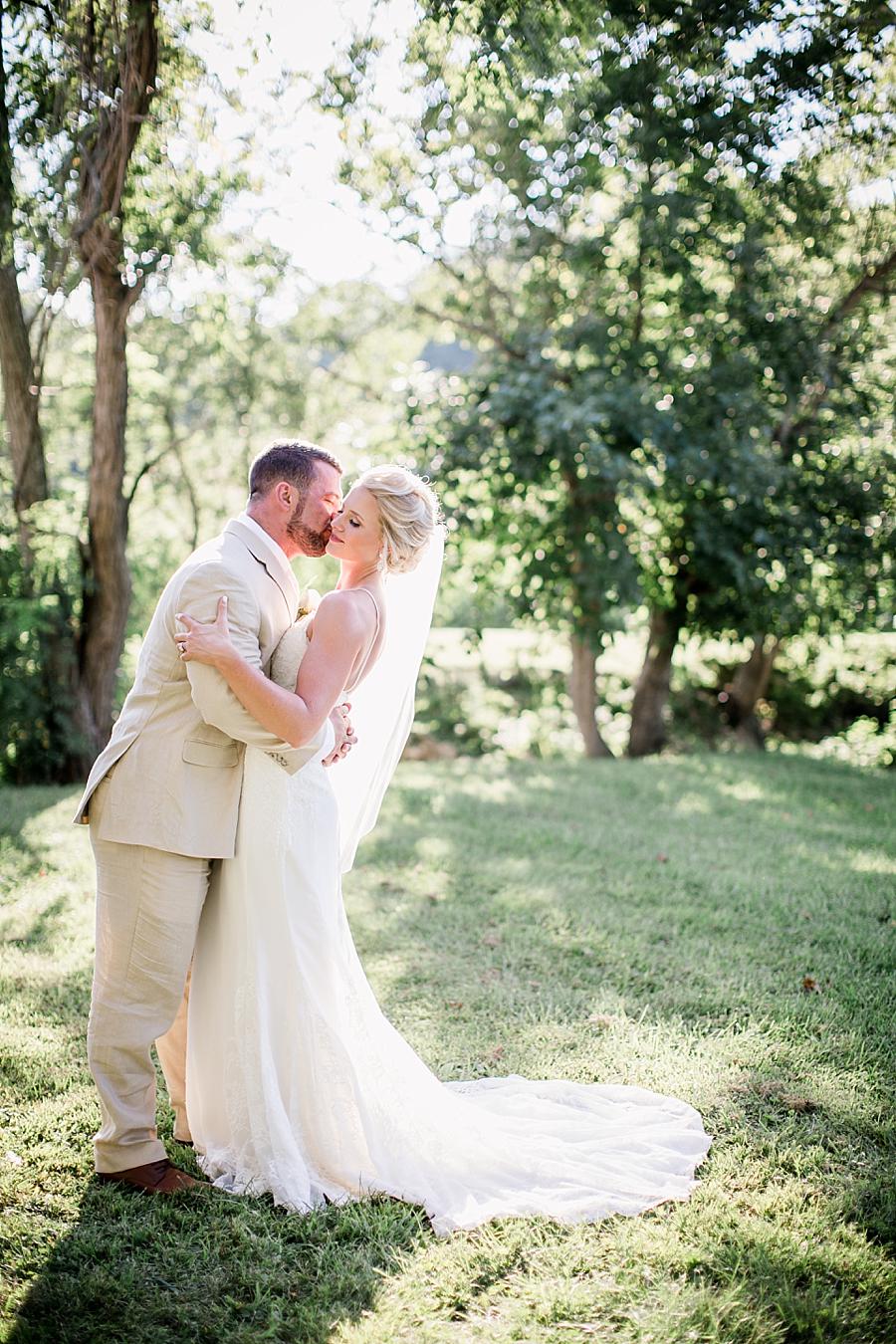 Kissing her cheek at these 2017 favorite weddings by Knoxville Wedding Photographer, Amanda May Photos.