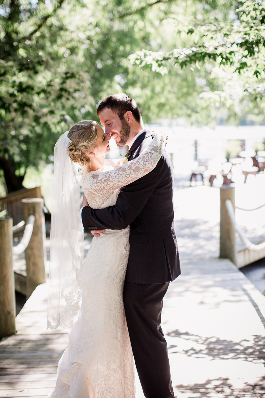 Almost kissing with her arms around his neck at these 2017 favorite weddings by Knoxville Wedding Photographer, Amanda May Photos.