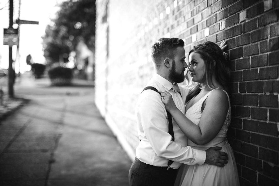 Leaning against a brick wall at these 2017 favorite weddings by Knoxville Wedding Photographer, Amanda May Photos.