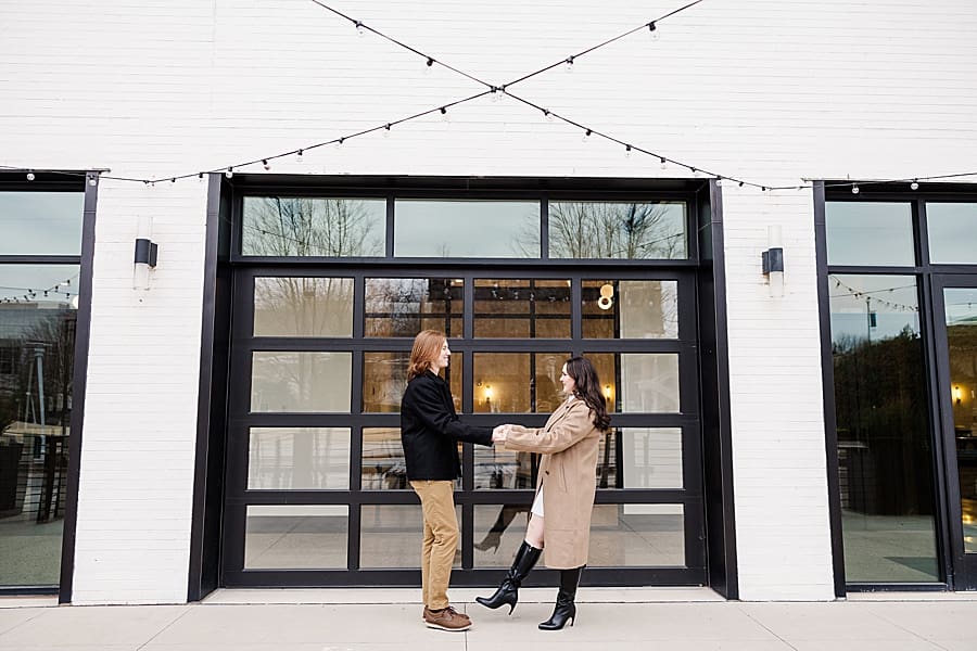 couple dancing in front of glass