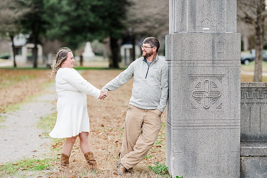 man leaning against concrete column at sequoyah hills engagement