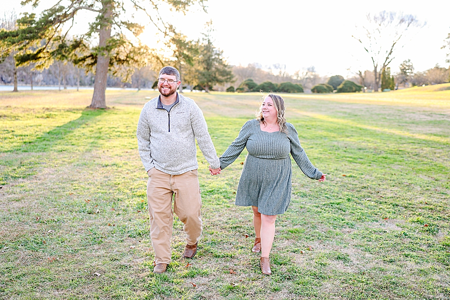 couple holding hands at sunset