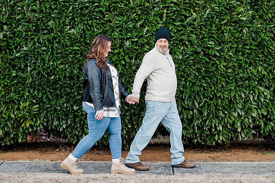 couple holding hands and walking together