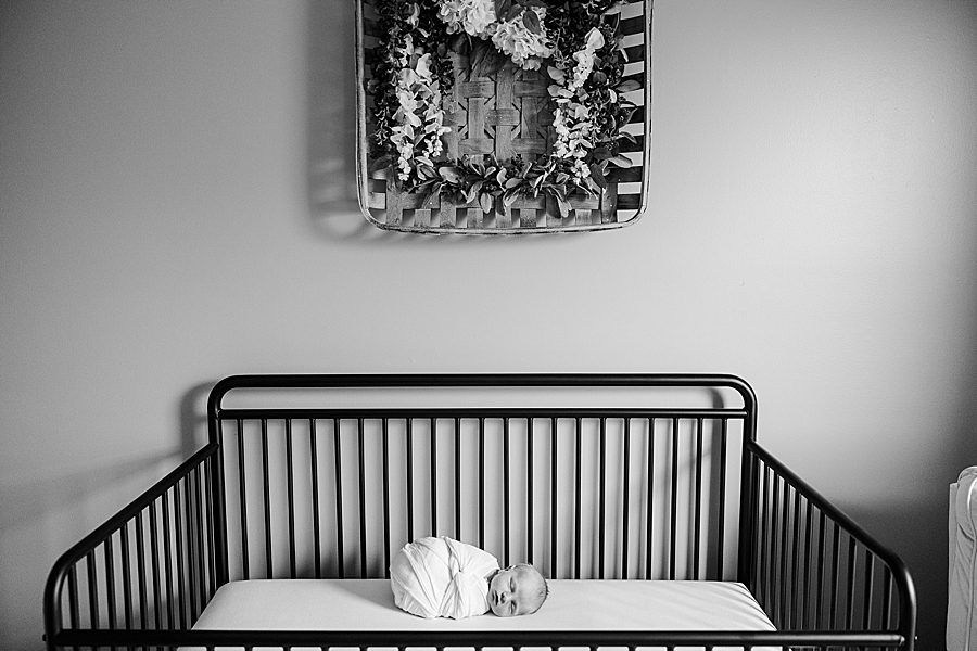 baby laying in crib at clinton newborn session