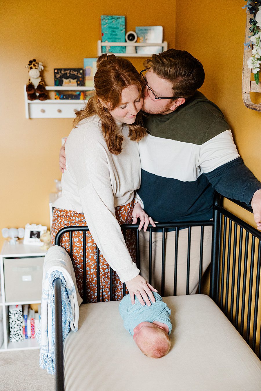 kiss on cheek at clinton newborn session