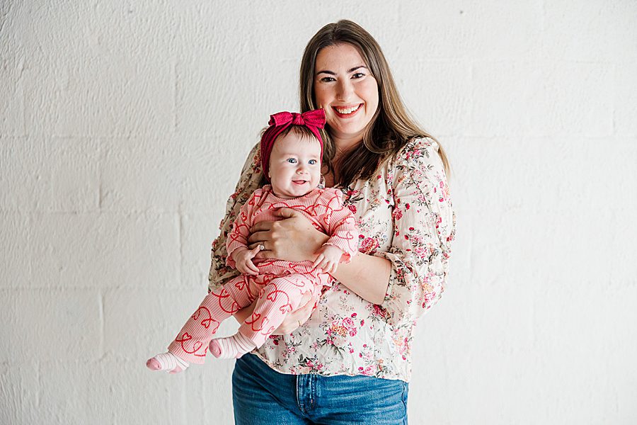 mom holding daughter at highlight studio 6 month session