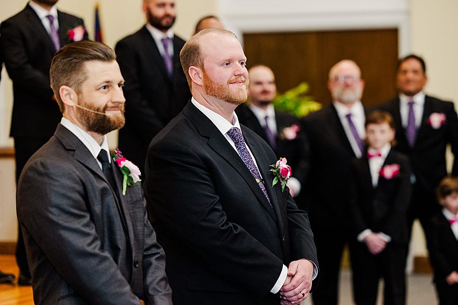 groom watching bride walk down aisle