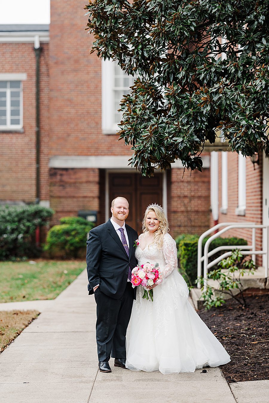 bride and groom under magnola