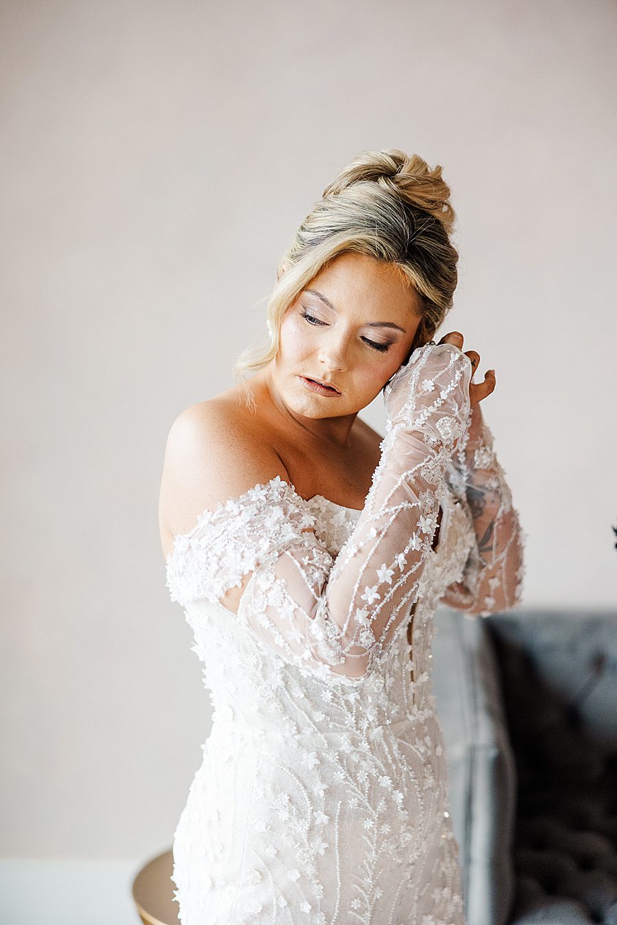 putting on earrings at winter trillium wedding