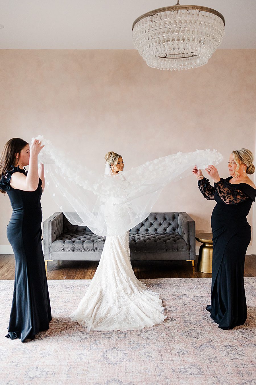 women fluffing bridal veil