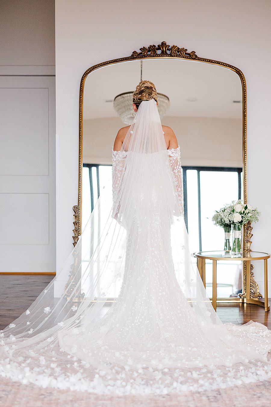 bride in front of mirror before winter trillium wedding