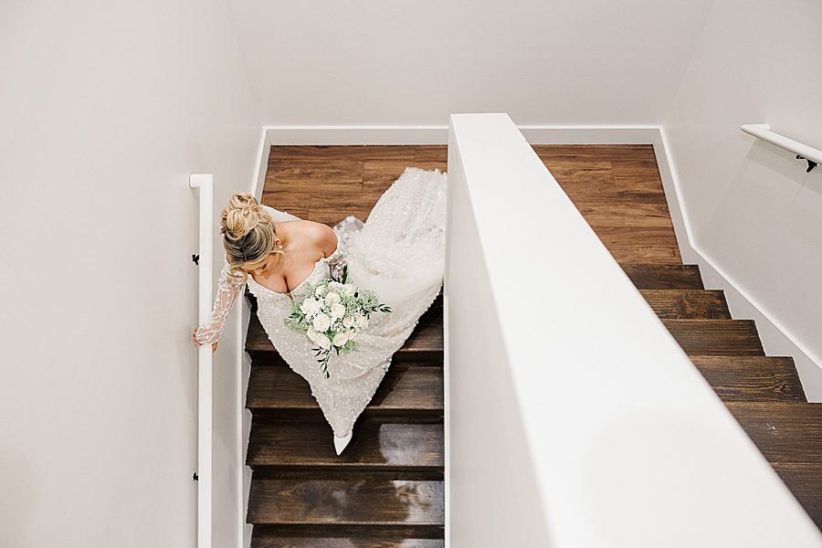 bride going down stairs before winter trillium wedding