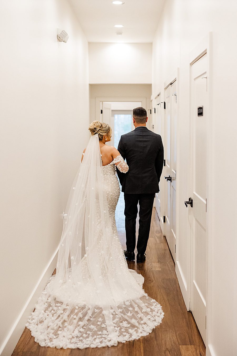 bride and groom walking down hall