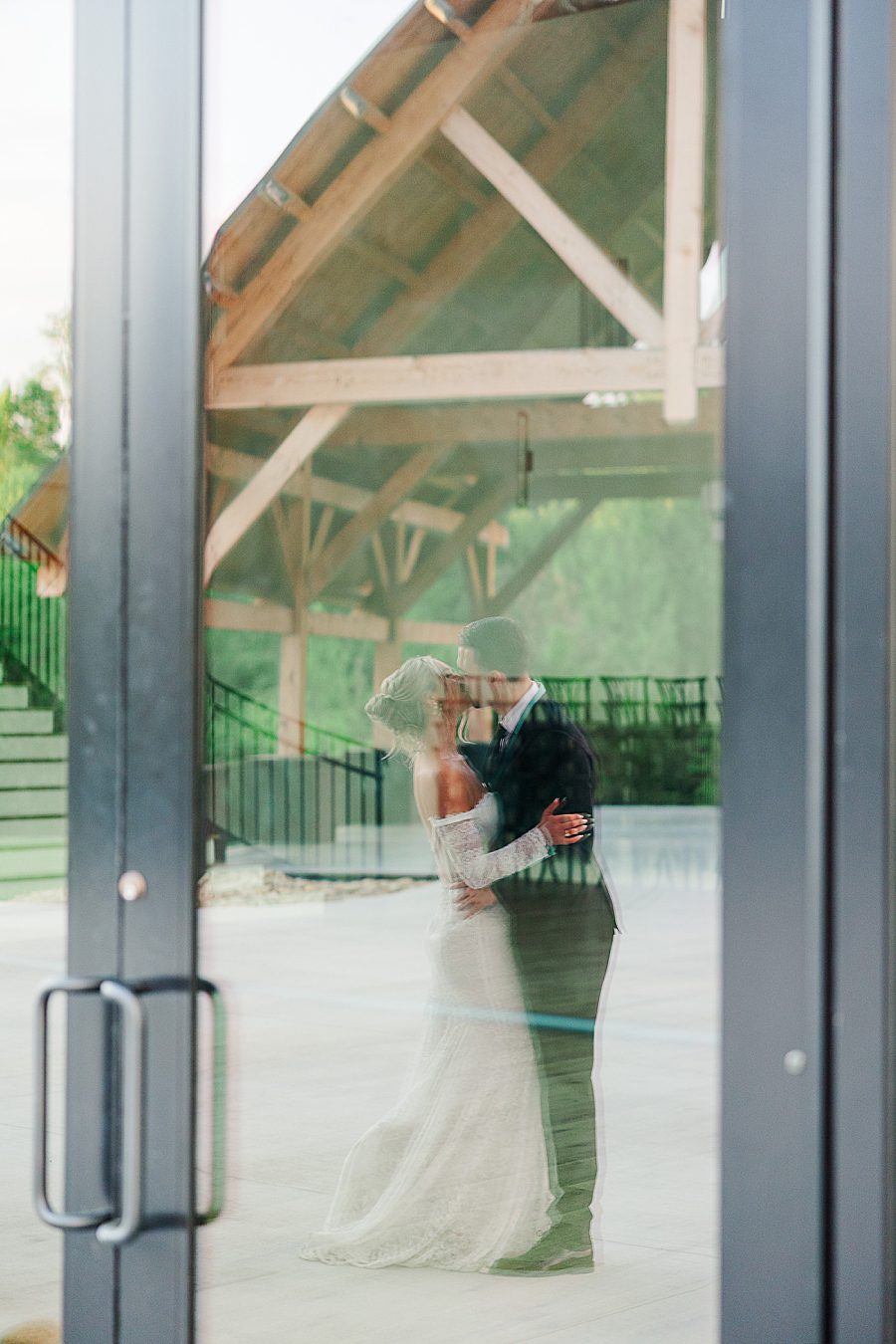 bride and groom reflection in glass
