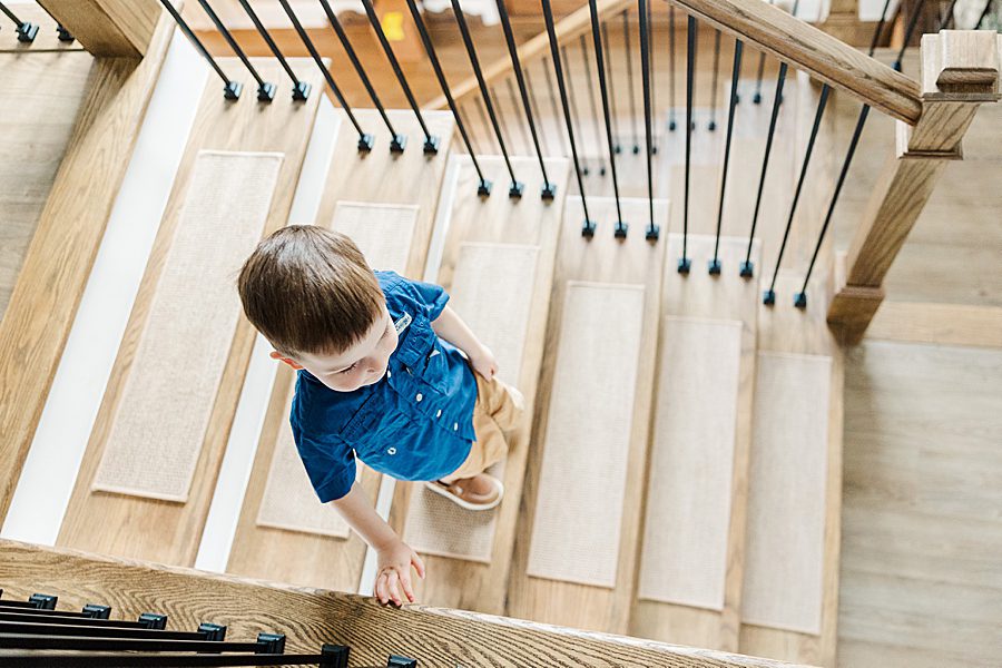 boy walking down wood stairs