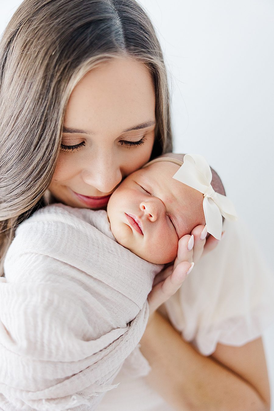 mama holding daughter at studio newborn session