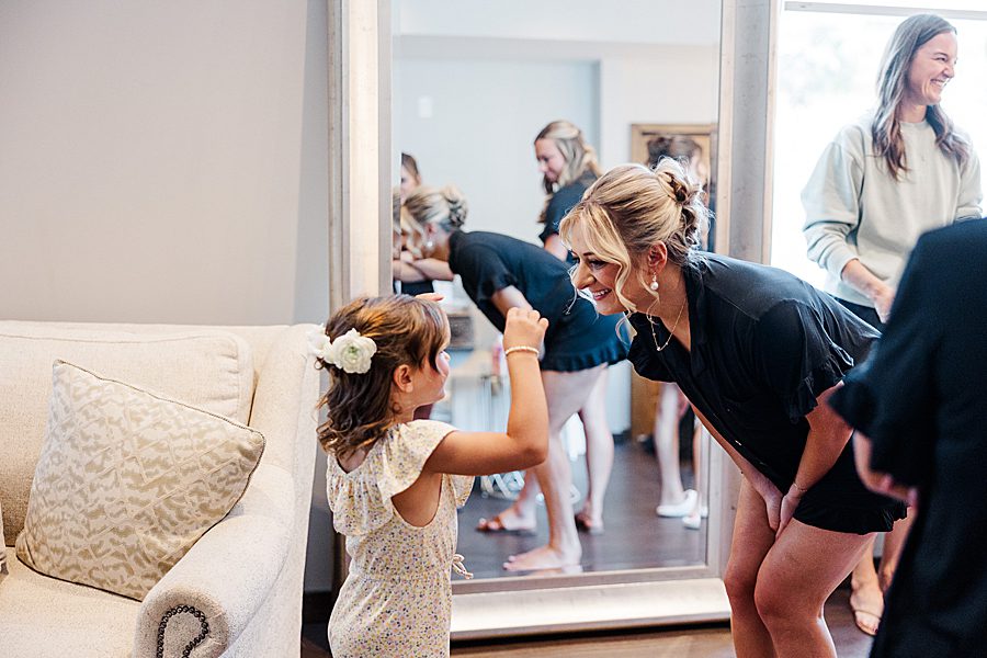 bride and flower girl before summer press room wedding