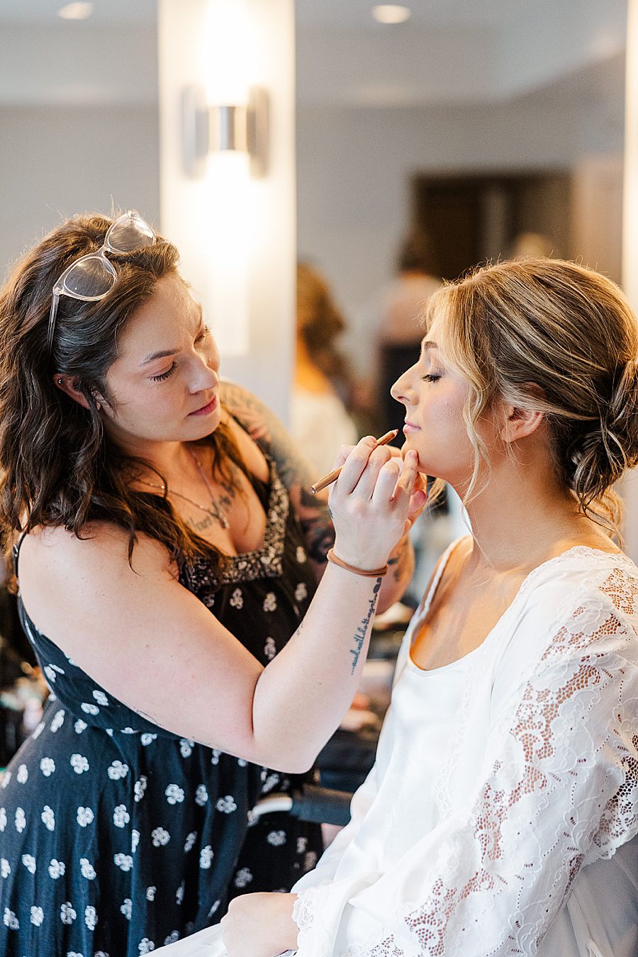 getting makeup done for summer press room wedding