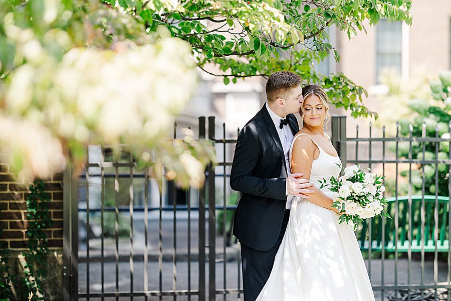 kiss on cheek at summer press room wedding