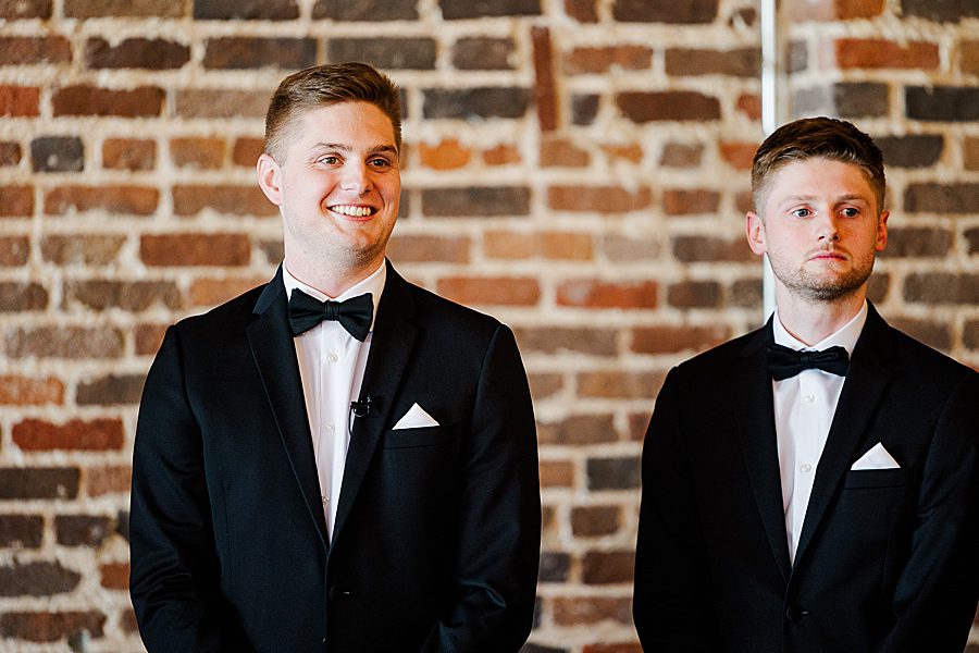 groom sees bride at summer press room wedding