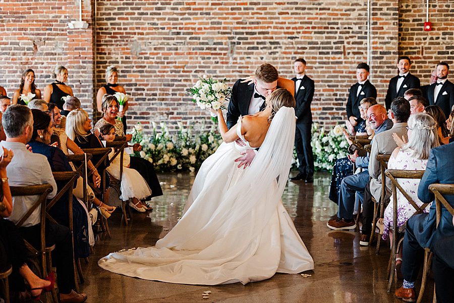 dip kiss at summer press room wedding