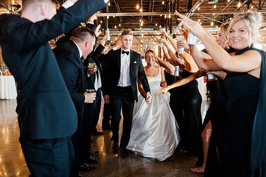 bride and groom entering reception
