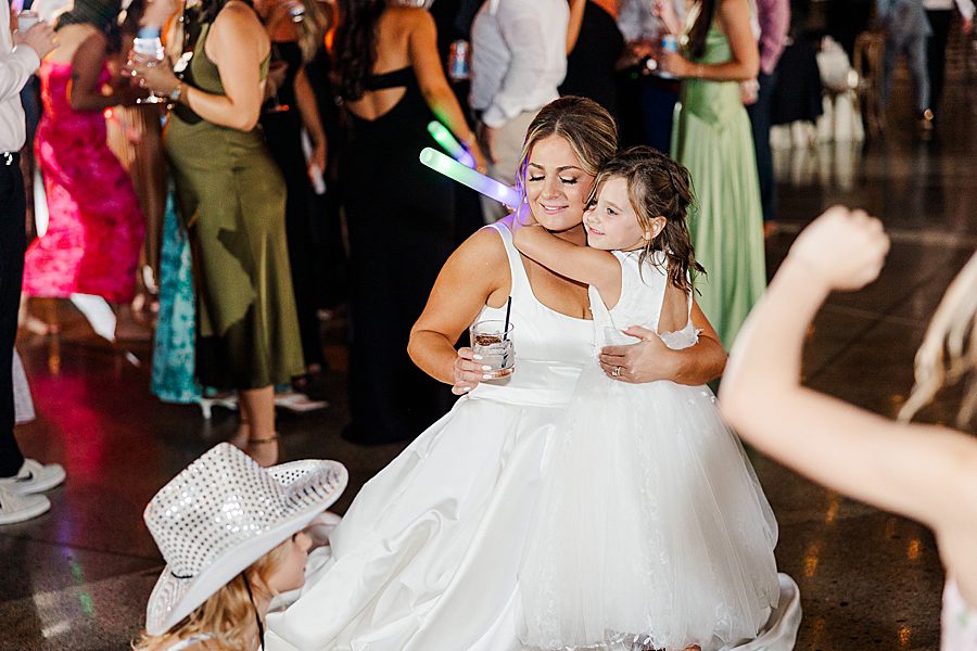 bride hugging flower girl
