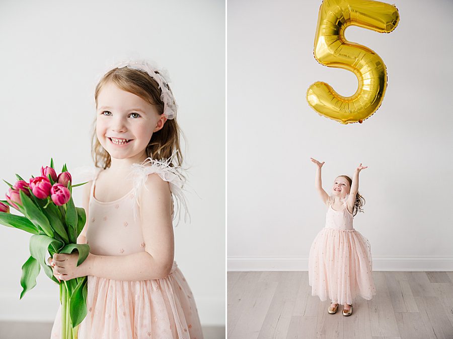 little girl playing with 5 balloon