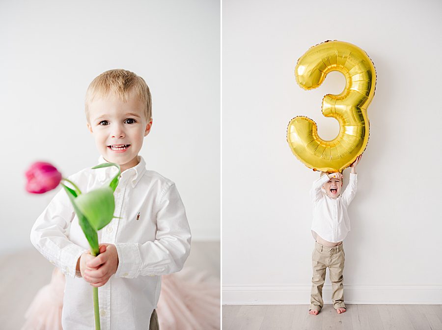 little boy holding 3 balloon