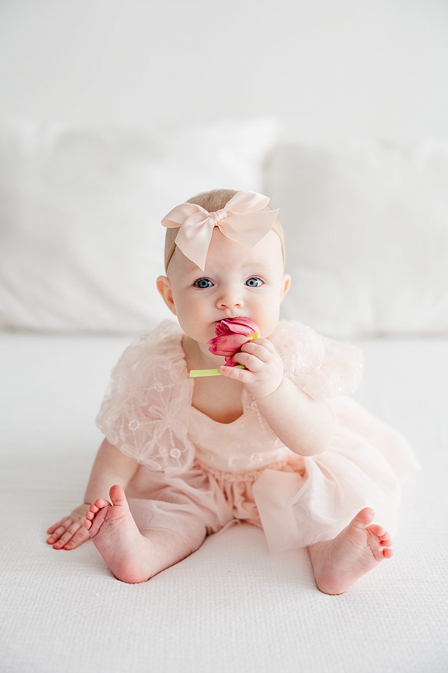 baby girl holding tulip